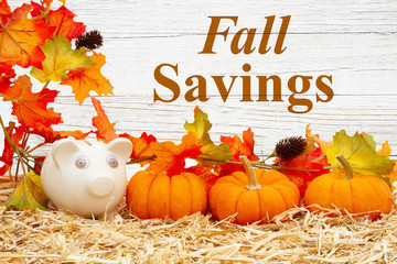 Wall Mural - Fall savings message with piggy bank and pumpkins and fall leaves on straw hay