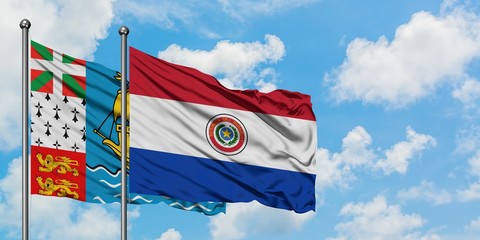 Saint Pierre And Miquelon and Paraguay flag waving in the wind against white cloudy blue sky together. Diplomacy concept, international relations.