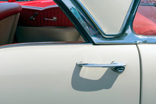 Close Up Of A White Classic Car With Red Interior And Loads Of Chrome.