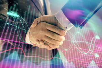 Multi exposure of forex graph on abstract background with two businessmen handshake. Concept of success on stock market