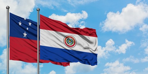 Samoa and Paraguay flag waving in the wind against white cloudy blue sky together. Diplomacy concept, international relations.