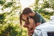 © standret - Behind the car. Beautiful young couple have a good time in the forest at daytime