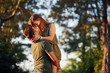 © standret - In love with each other. Beautiful young couple have a good time in the forest at daytime