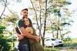 © standret - Embracing and looking far away. Beautiful young couple have a good time in the forest at daytime