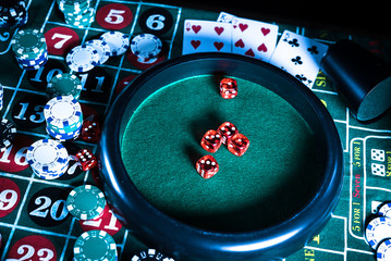 Wall Mural - Casino background, poker Chips on gaming table, roulette wheel in motion,