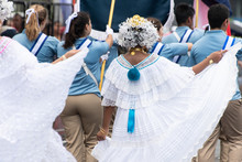 Unidentifiable Woman Wearing Traditional White Panamanian Dress And Other People In The Street During Panama National Day Parade Celebrating The Separation Of Panama From Colombia. Selective Focus.