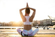 © Rafa CortÈs/Westend61 - Rear view of Asian woman practicing yoga on a pier at harbor in the evening
