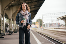 Young Female, Traveler With Coffee To Go On Train Station