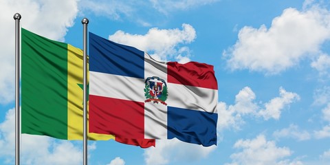 Senegal and Dominican Republic flag waving in the wind against white cloudy blue sky together. Diplomacy concept, international relations.