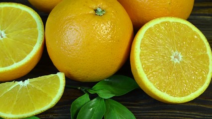 Wall Mural - sliced oranges spin on wooden table