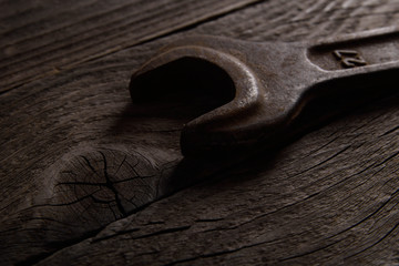 Poster - Different workpieces on a wooden background. Hedge wrenches keys, hammer