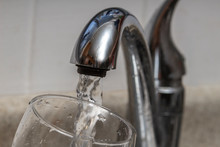 Glass At Water Tap And Filling Water With Lead Contamination