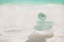 Blue Sea Glass With White Sand Beach