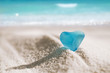 © Elena Moiseeva - sea glass blue heart on white sand beach