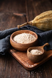Organic baobab powder in a wooden bowl, healthy sport nutrition rich in vitamins and minerals