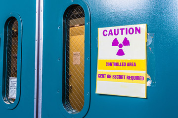 Ionizing radiation warning symbol displayed at the entrance to a laboratory; Message posted: 