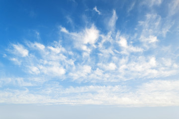 Wall Mural - a lot of light semitransparent clouds floating high in a blue sky. scenic cloudscape on a sunny autu
