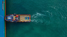 Aerial Top Down View Of Tug Pilot Boat Assist Vessel Pushing Large Tanker To Position, Keratsini, Attica, Greece