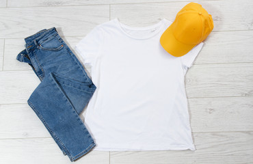 Wall Mural - T-shirt top view, t shirt mock up, empty tshirt. Summer concept casual clothes background copy space. Blank shirt on wooden background