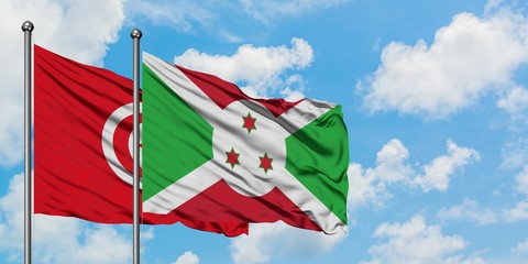 Tunisia and Burundi flag waving in the wind against white cloudy blue sky together. Diplomacy concept, international relations.