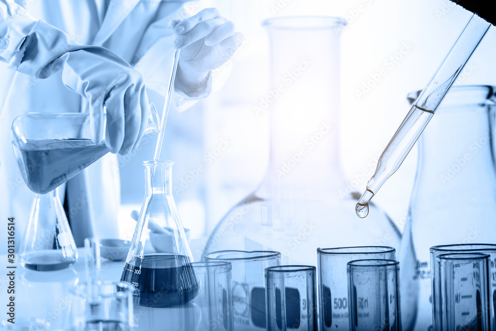 hand of scientist holding flask with lab glassware and test tubes in ...