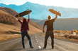 © cppzone - Couple longboarders at straight mountain road