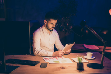 Sticker - Workaholic stay evening office concept. Focused marketer work on his modern tablet search information about company enterprise development sit table in dark loft company