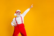 © deagreez - Portrait of funny crazy santa claus hipster in red hat fun christmas x-mas party celebrate newyear time dance raise index finger wear shirt suspenders isolated yellow color background