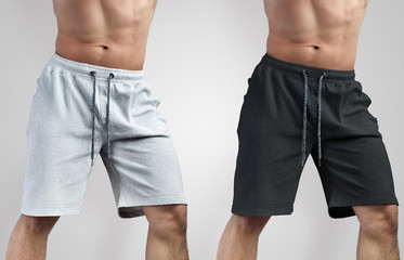 Design mockup of white and black shorts on a young guy, front and side view.