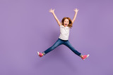 Full length photo of funny small foxy lady jumping high rejoicing making star shape in air cheerful crazy mood wear casual t-shirt jeans isolated purple background