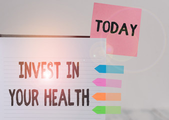 Word writing text Invest In Your Health. Business photo showcasing Live a Healthy Lifestyle Quality Food for Wellness Hard cover note book sticky note arrow banners inserted clear background