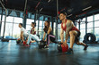 © master1305 - A group of muscular athletes doing workout at the gym. Gymnastics, training, fitness workout flexibility. Active and healthy lifestyle, youth, bodybuilding. Training in lunges and stretching with ball