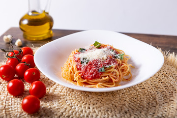 Wall Mural - Spaghetti with tomato sauce and grana padano cheese. Classic dish of Italian tradition. Healthy eating, italian food