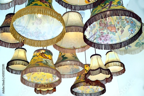 Fotomural Antique or vintage lampshades hanging in a display group