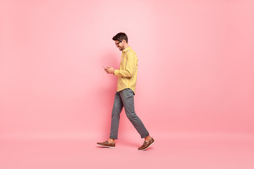 Aufkleber - Full size profile photo of handsome guy going street finished working week typing girlfriend sms telephone wear specs striped shirt pants isolated pink color background