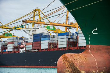 Container crane loading cargo in container ship in Maritime port  and Container Harbor. Transportation industry and shipping logistics. Export and import bussines