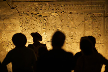 Wall Mural - group of unrecognizable tourist archeologists standing in silhouette in front of ancient egyptian hi