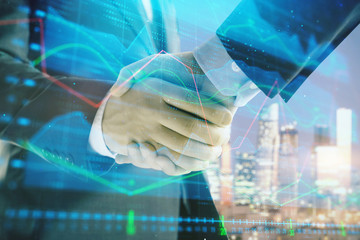 Double exposure of financial chart on cityscape background with two businessmen handshake. Concept of financial analysis and investment opportunities