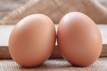 Close up chicken eggs with wooden background