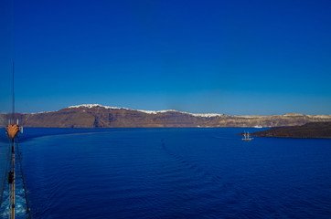 Luxury cruise ship liners during Mediterranean cruise in the Aegean Sea anchoring in the crater caldera of Greek Island Santorin Santorini with beautiful white houses and architecture panoramic  view