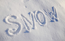 The Words SNOW Are Written In Snow. Written Word On A Snow White Field.