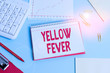 © Zofia - Handwriting text Yellow Fever. Conceptual photo tropical virus disease affecting the liver and kidneys Paper blue desk computer keyboard office study notebook chart numbers memo