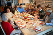© luckybusiness - Family and friends at  Christmas dinner.Christmas eve with traditional food.