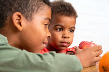 Poster - African American brothers having breakfast with an apple