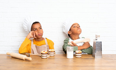 Wall Mural - Two African American brothers kids dressed as chef and thinking