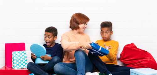 Wall Mural - African American kids with their mother among many gifts for christmas holidays