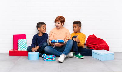 Wall Mural - African American kids with their mother among many gifts for christmas holidays