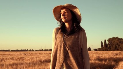 Poster - landholder walks across the field with ripened wheat golden light sunset in countryside