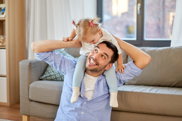 Canvas Print - family, parenthood and fatherhood concept - happy father riding little baby daughter on his neck at home