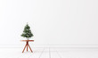 Small Christmas tree in white empty interior 3D Rendering
